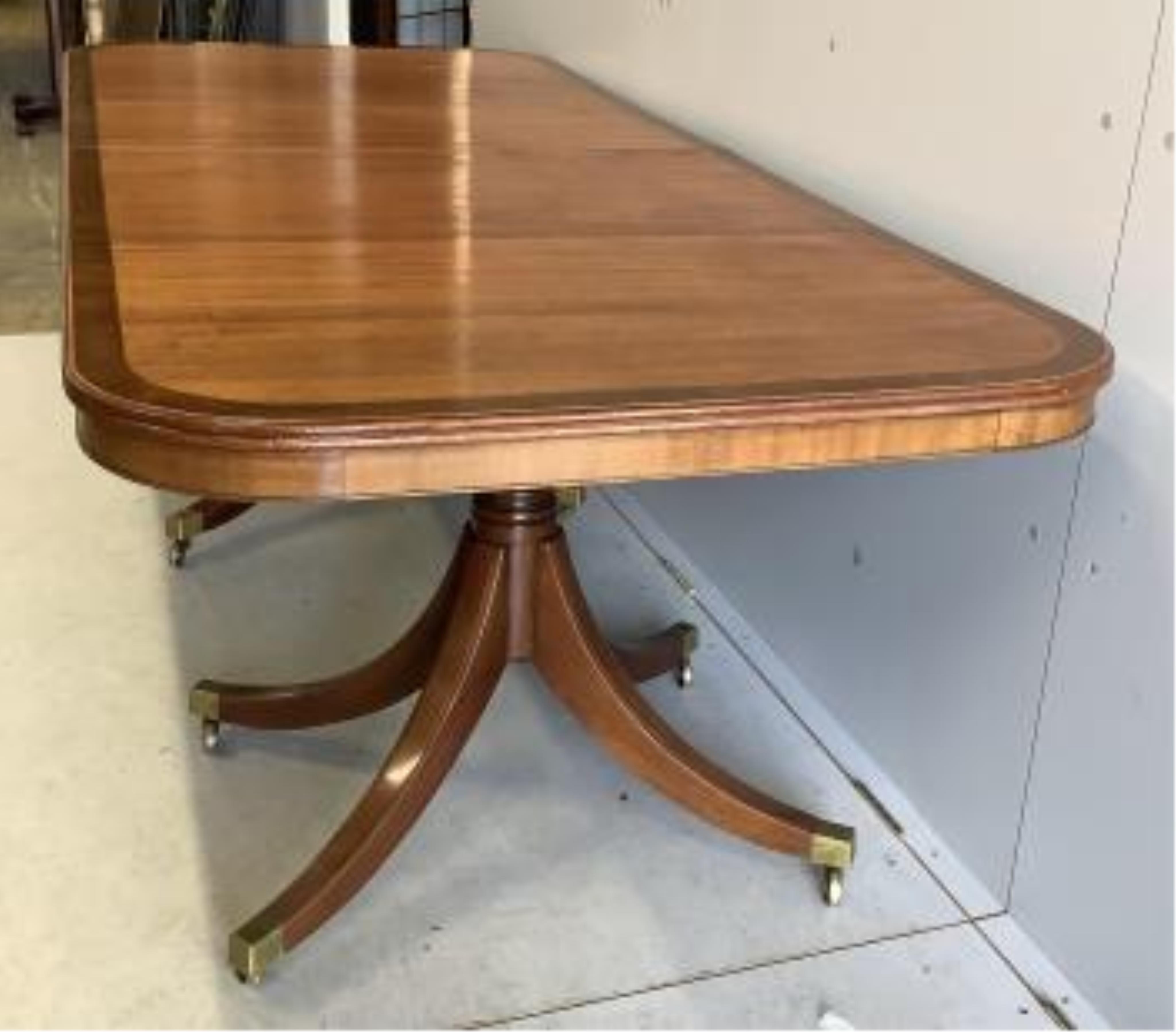 A reproduction mahogany twin pillar extending dining table, extended 300cm, two spare leaves, depth 91cm, height 72cm. Condition - good